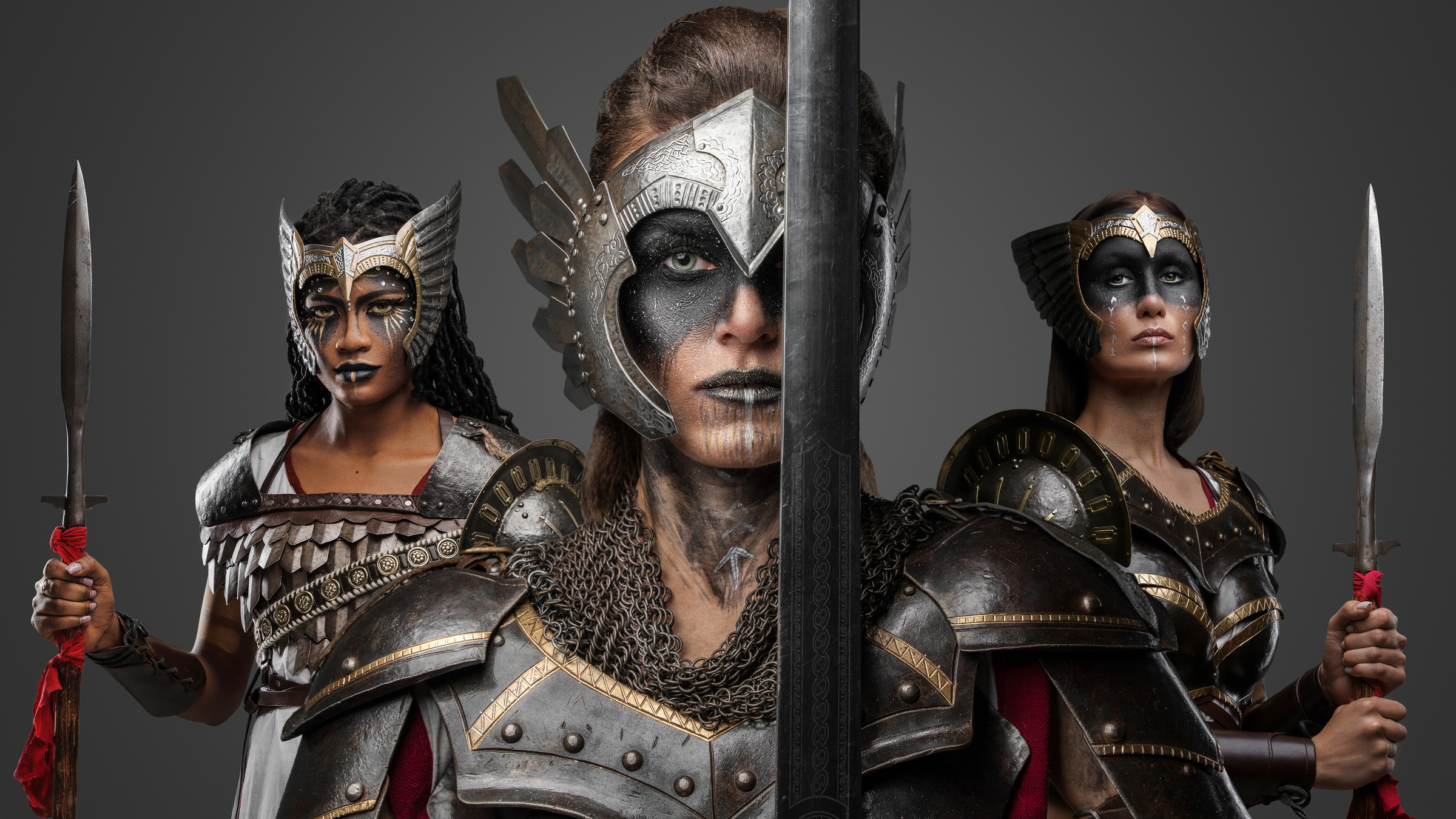 Three Warriors Women with Cold Steel against Gray Background